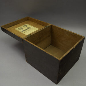 Holbrook eight-inch terrestrial globe box, stained oak, hinged lid open showing pasted printed paper trade label inside